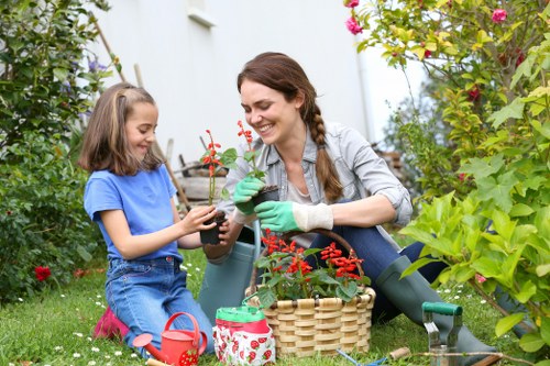 Gardener performing seasonal maintenance in a London back garden